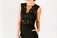 a chic black sleeveless bridesmaid’s jumpsuit with an illusion neckline and a shiny bodice for a wow look