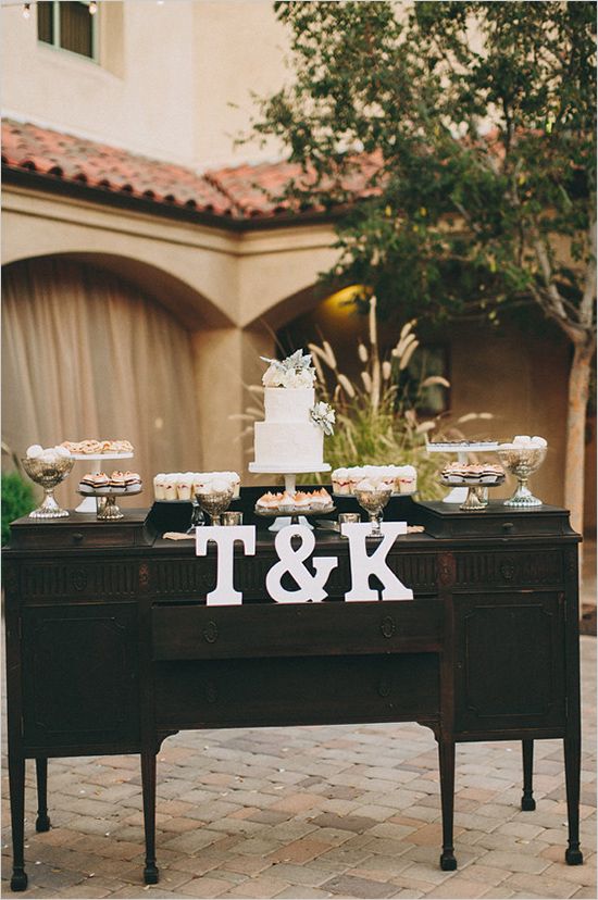 a dark vintage dresser as a wedding dessert table, with monograms and various sweets is a lovely idea for a wedding