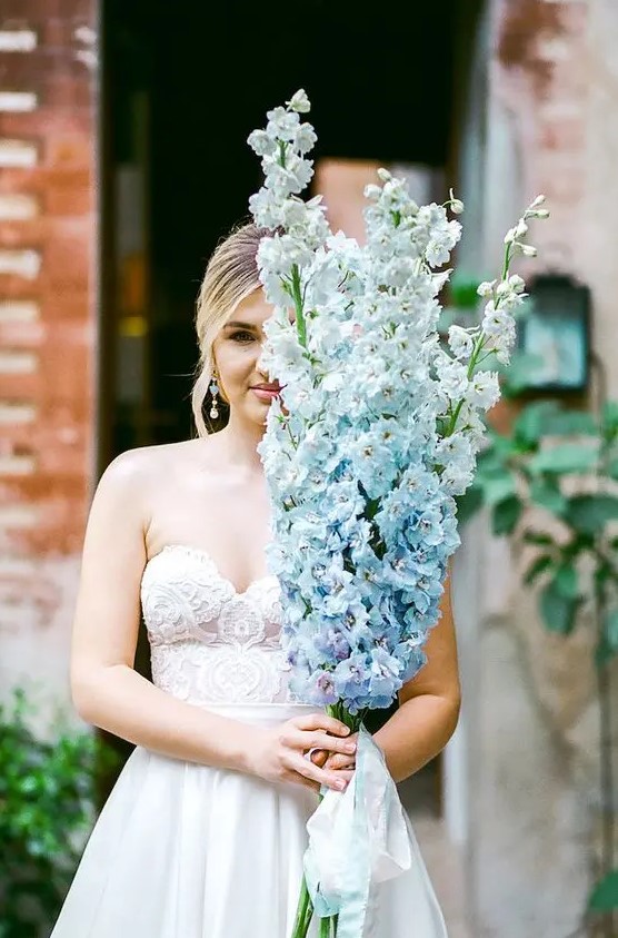 a gorgeous long-stem wedding bouquet of serenity blue delphinium is a fantastic idea for a delicate and refined bridal look