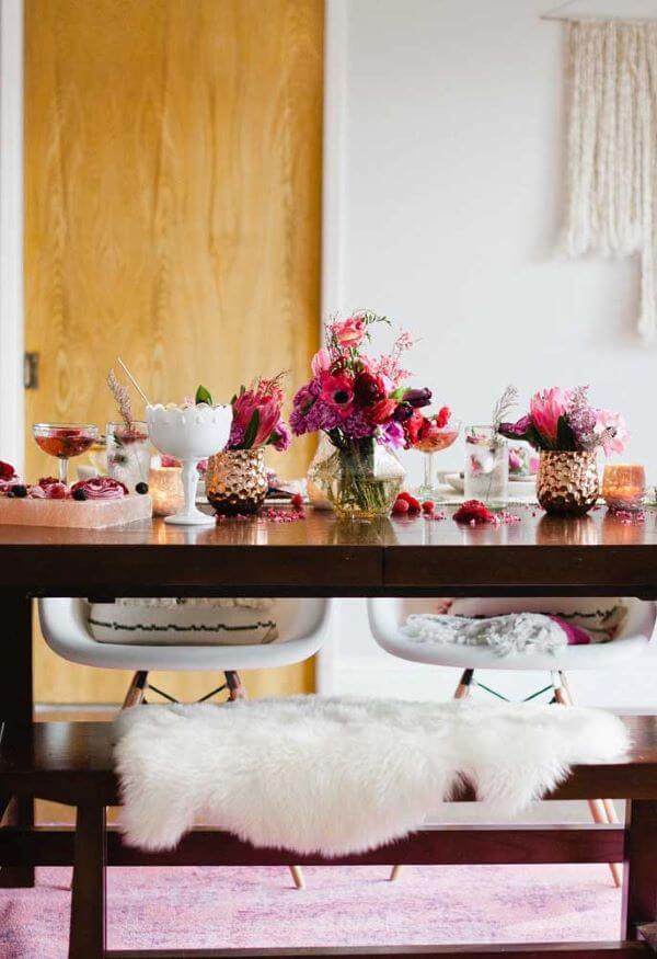 a lovely Valentine's Day engagement tablescape with lots of blooms, petals and delicious drinks and cupcakes