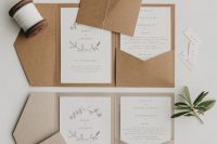 a neutral and organic wedding invitation suite with kraft paper envelopes and neutral invites with botanical prints and patterns