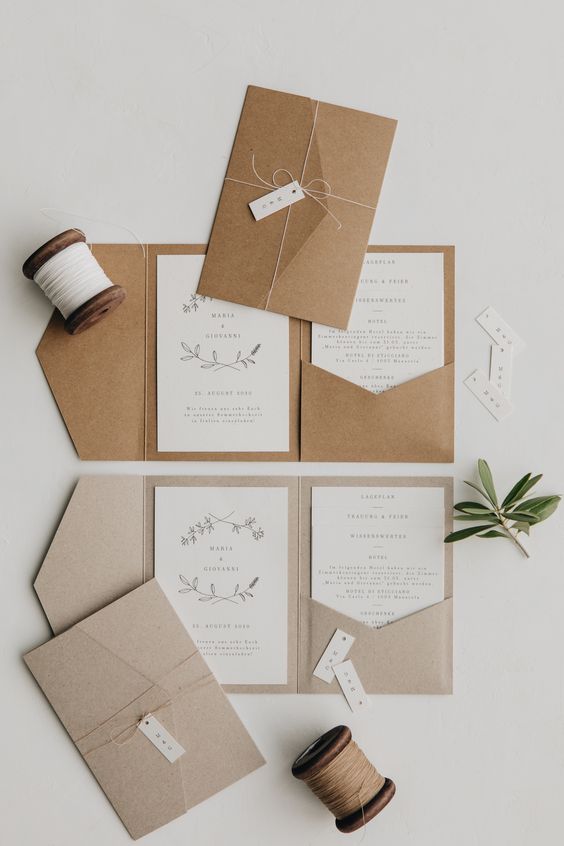 a neutral and organic wedding invitation suite with kraft paper envelopes and neutral invites with botanical prints and patterns