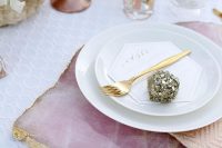 a pink quartz placemat with a gold edge is a refined and chic idea for decorating your wedding reception tables