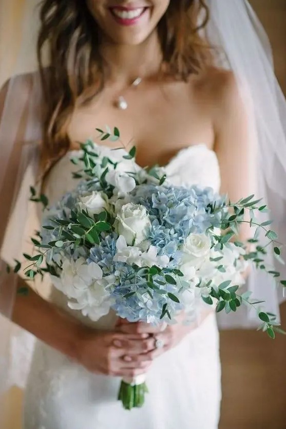 a pretty and chic wedding bouquet of white roses and blue hydrangeas and greenery is a lovely idea for a spring wedding