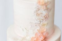 a romantic white wedding cake decorated with rose quartz and more textures for a cool look