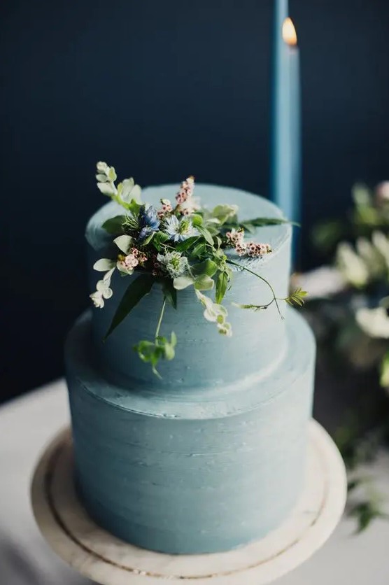 a serenity blue wedding cake with textural buttercream covered tiers and some fresh blooms and greenery on top is a gorgeous idea for spring
