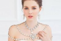 a sophisticated rhinestone shoulder jewelry piece paired with matching floral earrings for a statement look