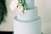 a textural serenity blue wedding cake decorated with white blooms and greenery is a great idea for a spring or summer wedding
