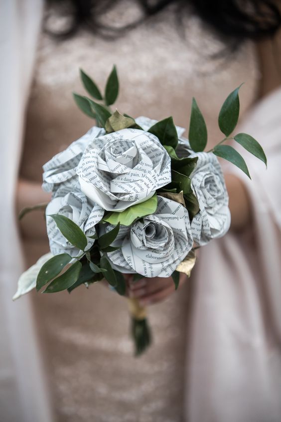 a unique wedding bouquet of newspaper flowers and fresh greenery is a cool solution for a wedding