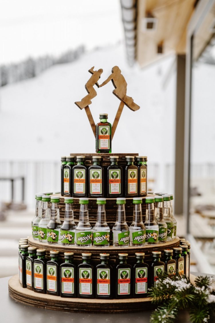 a wedding bar of bottles with wooden snowboard toppers is a gorgeous idea for a snowboarding wedding