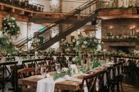 an elegant rustic ski resort reception with greenery and white blooms, white linens and candles is amazing