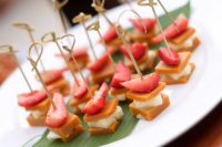 cheese and caramel sandwiches topped with strawberries and on skewers are adorable, delicious and very cool