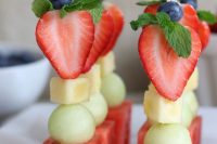 fruit kabobs of watermelon, pear, melon, cheese, strawberries, blueberries and herbs on top are amazing for Valentine weddings