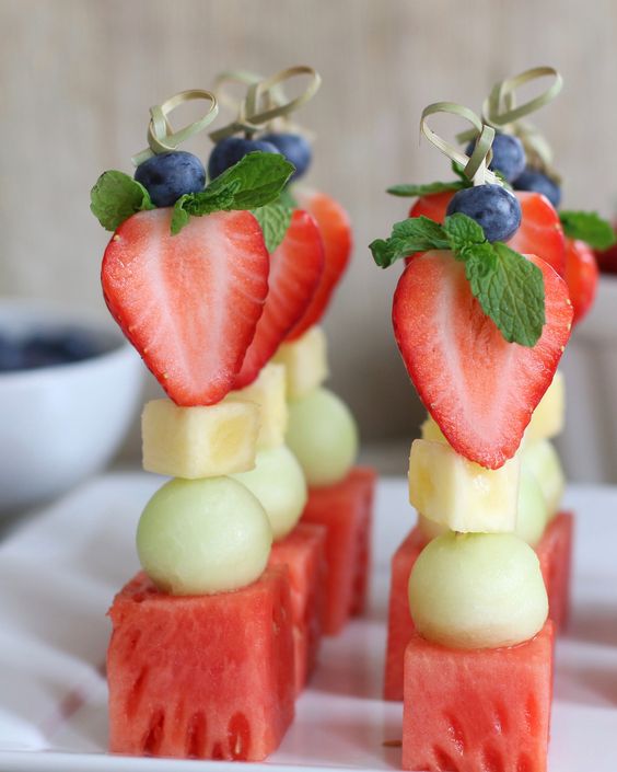 fruit kabobs of watermelon, pear, melon, cheese, strawberries, blueberries and herbs on top are amazing for Valentine weddings