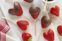 heart-shaped strawberries on skewers are easy to dip them into chocolate and ideal for a Valentine wedding