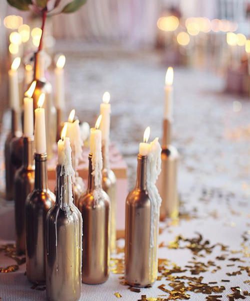 lots of gold wine bottles with candles on top will be great aisle liners or can be used anywhere else in your wedding venue