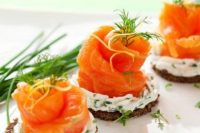 mini tarts with cream cheese and herbs and salmon on top are delicious Valentine appetizers to enjoy