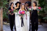 mismatching black jumpsuits and lacey black heels for all the bridesmaids to contrast the white bridal look