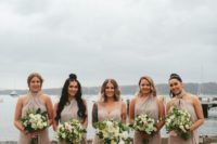 off-white bridesmaid jumpsuits with various necklines and wideleg pants is a comfy modern idea for your bridal party