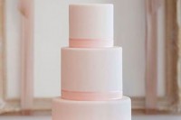 a rose quartz wedding cake with ribbons and a ruffle tier looks refined, chic and very romantic