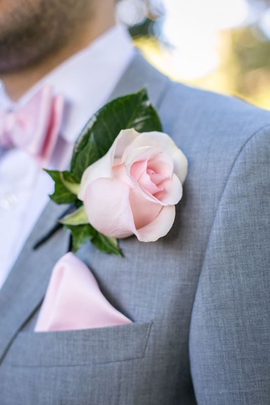 a pink rose, a rose quartz bow tie and a handkerchief for making the groom's look romantic and chic
