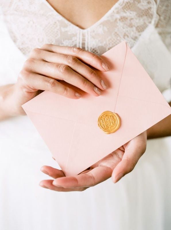 a rose quartz envelope with a seal is a cool idea for wedding invitations or other wedding stationery
