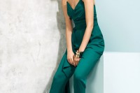 a fitting strapless emerald jumpsuit with a sculptural draped bodice and nude sandals for a bright bridesmaid look