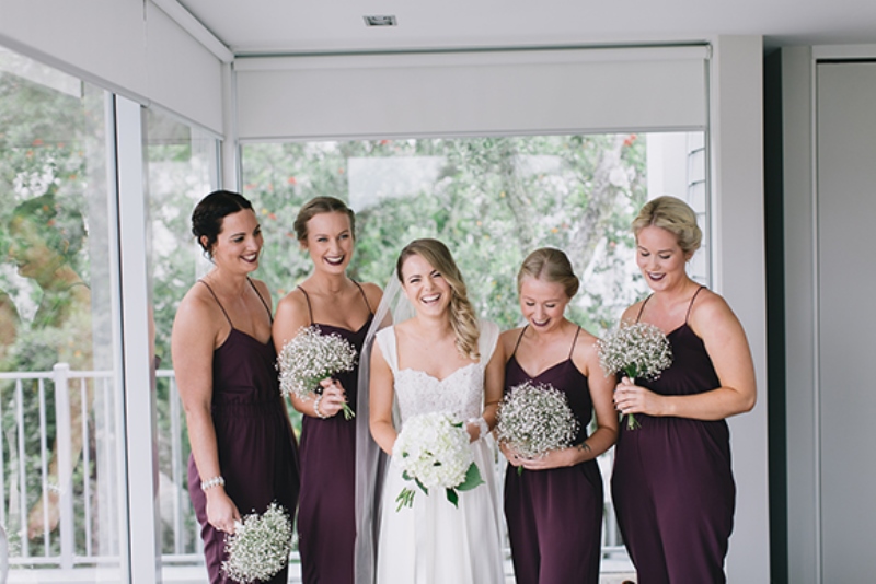 Fitting purple spaghetti strap jumpsuits with draped bodices are great for a fall wedding