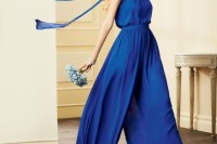 a bright blue halter neckline jumpsuit with a highlighted waist and wideleg pants plus long ties on the back