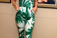 a strapless fitting jumpsuit with a tropical print, red shoes and statement earrings for a summer or tropical wedding