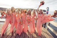 sleveless coral pink bridesmaid jumpsuits with a ruffled bodice and wideleg pants for a summer wedding