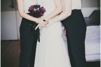 elegant black and white bridesmaid jumpsuits with studded shoulders, statement earrings and platform shoes