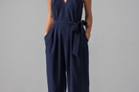 a navy thick strap sleeveless jumpsuit with wideleg pants and pockets and a sash for an accent