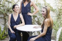 elegant sleeveless navy bridesmaid jumpsuits with deep V-necklines and black heeled sandals is a chic and stylish combo
