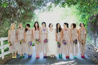 off-white bridesmaid jumpsuits with wideleg pants and colorful mismatching shoes and necklaces