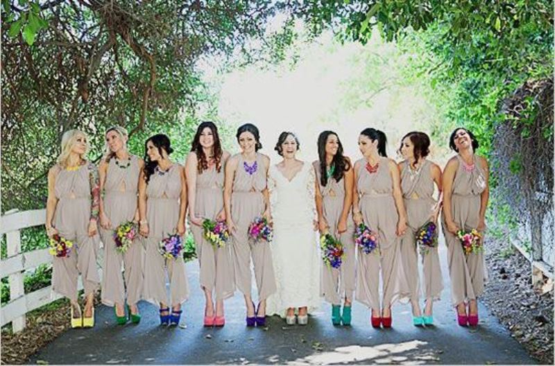 off white bridesmaid jumpsuits with wideleg pants and colorful mismatching shoes and necklaces