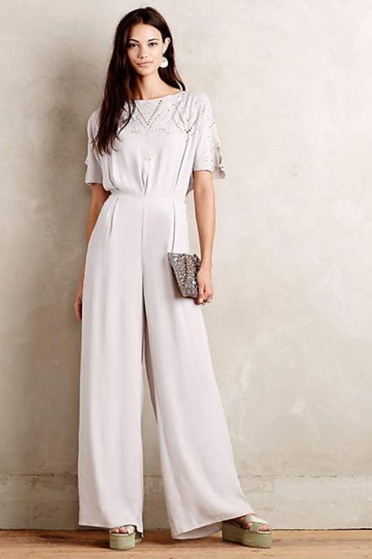 an off-white jumpsuit with a crochet top, short sleeves and wideleg pants plus platform shoes