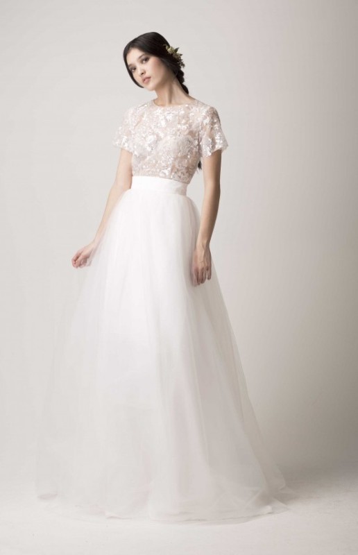 a stylish modern separate with an embellished top with short sleeves and a layered tulle skirt with a train