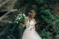 a ballerina wedding look with a plain top plus illusion lace sleeves and a full tulle skirt is very chic