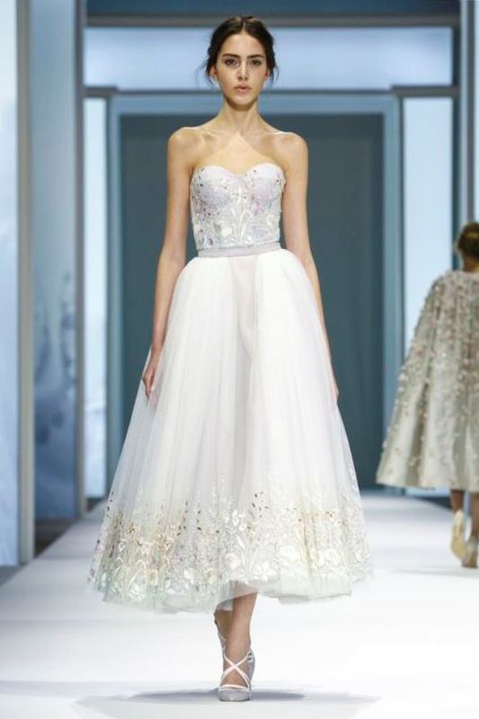 a strapless midi wedding dress with a bustier top and a full skirt with colorful floral embroidery for a wow look