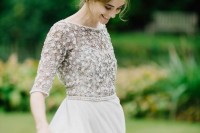 a modern wedding look with a grey embellished and applique bodice with short sleeves and a neutral layered skirt