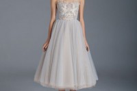 a light blue strapless A-line wedding dress with a full tulle skirt and floral embroidery for a romantic and chic look
