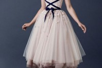 a gorgeous blush midi wedding dress with floral appliques and navy velvet ribbon lacing up the bodice looks very ballerina-like