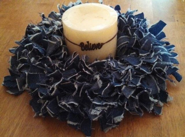 a candle wrapped with a lush denim wreath and a letter pendant is a fun and quirky cowboy decoration