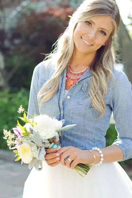 a bride covering up with a chambray shirt is a cool and bold idea, you may also try a denim jacket instead