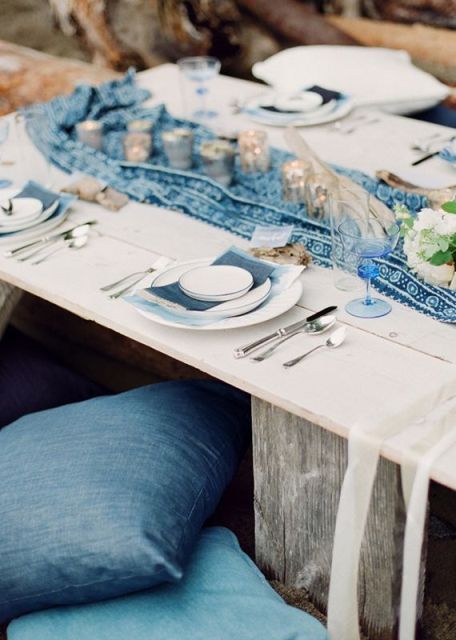 denim pillows and menues match a blue printed table runner and make the table relaxed boho and casual