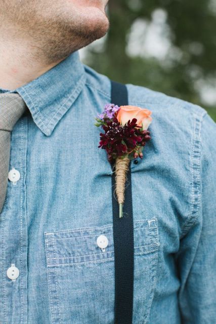 a denim shirt with a neutral tie and suspenders is a cool idea for a rustic or a cowboy wedding