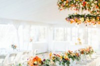 colorful floral and greenerry chandeliers with bulbs will make your wedding reception space amazing, bold, cheerful and lit up
