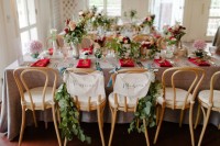 bright blooms and greenery centerpieces and greenery chair decor make the reception space cozier