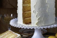 a white textural buttercream wedding cake topped with cut lemons is a perfect idea for a summer wedding